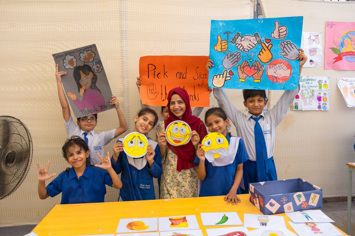 DeafPakistan's tweet photo. Our students took center stage to mark International Day of Sign Languages, bringing energy, creativity, and connection to our Karachi Campus. 

Visitors from other companies and team members from our Head Office engaged with the students, who designed and led interactive activity stalls and welcomed everyone into their classrooms for collaborative games—a powerful demonstration of Pakistan Sign Language (PSL) in building truly inclusive spaces.

The celebration closed with reflections on the global significance of sign language rights, followed by a ceremonial cake cutting.

When we give Deaf youth the platform to lead, they show us what true inclusion looks like. Every child deserves the chance to learn, grow, and express themselves in a language of their own. 💙

🌐 Explore PSL learning tools: https://t.co/fmljq2f6aN | https://t.co/van2GbFRCF