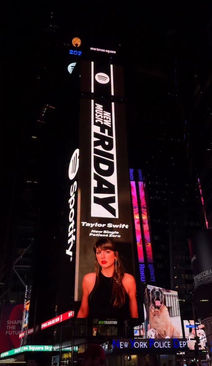 TSNews_13's tweet photo. 🚨| Taylor Swift stuns on a Times Square billboard promoting her new single “Patient Zero,” now available on Spotify. https://t.co/4qRAgD0Aqg