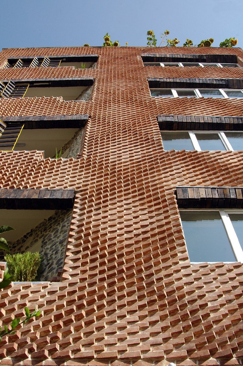 shavnyuyngah's tweet photo. Brick can be sculpted. Iranian architects have been proving it for years.

Not laid flat and plastered over. Rotated, folded, cast into diamonds, twisted into curtains, shaped into deep shading screens that block sun and hold privacy at the same time. Every building here is using the same material we already have, brick, just handled by hands that spent years mastering it.

That is the missing piece. Not the material. The mastery.

We need labor that does more than follow instruction. We need craftsmen who understand material well enough to push it, the way these builders did. Skill like that takes years, patience, and real investment, and it is the only way we start building with what we already have in abundance.