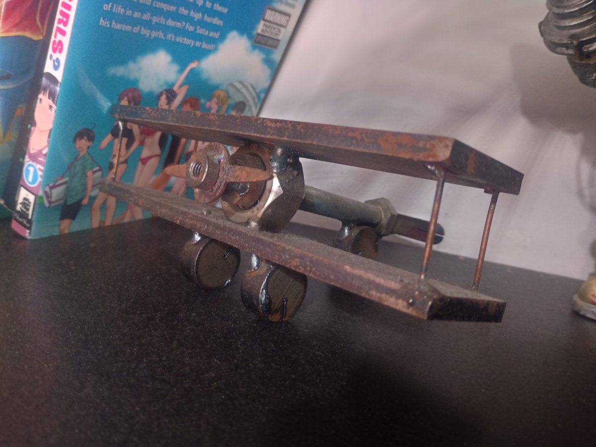 Sage67517539's tweet photo. Another metal biplane, I made this one to hold up my books probably about 5 or so years ago. In the coming months I'm replacing him with something way better : ) #metalart https://t.co/FZxtvtQ2F3