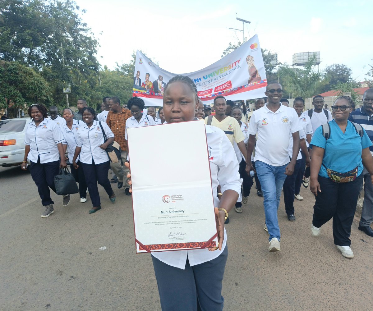 Muni_University's tweet photo. @KagutaMuseveni @MastercardFdn @ntvuganda @Educ_SportsUg @Parliament_Ug @ceforduganda Sharon, Senior Office Attendant in the Office of the Academic Registrar, carries the AHEFT Prize award certificate during the procession as Muni University celebrates this landmark achievement https://t.co/mjUF5mr8fv