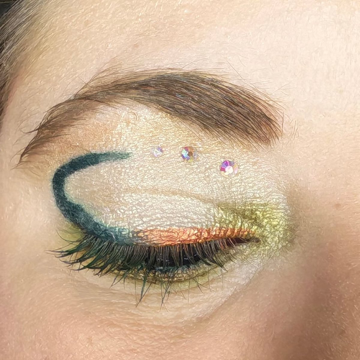 IanKozatek's tweet photo. Éclat sauvage : reflets dorés, vert intense et touches scintillantes pour capter la lumière. Un maquillage créatif et audacieux, pensé pour exprimer sa personnalité sans limites. https://t.co/ViNWtU41Lr