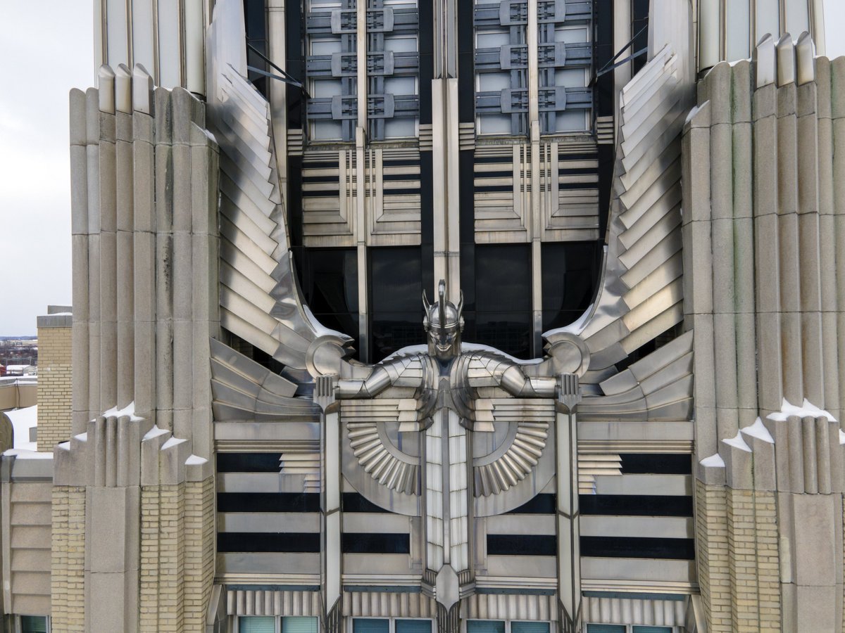 gietzschean's tweet photo. Art Deco actually made a power company building look exactly like a power company. 

The Niagara Mohawk Building in Syracuse was completed in 1932 as the headquarters of Niagara Hudson Power Corporation.

At night, concealed lights within the façade, illuminated glass panels, floodlighting on the central 'Spirit of Light' sculpture, reflective aluminum, polished glass and stainless steel turned the building into a glowing advertisement for the power of electricity in the age of machine. 

This also represented the optimism and beauty that could be incorporated into modernist structures.