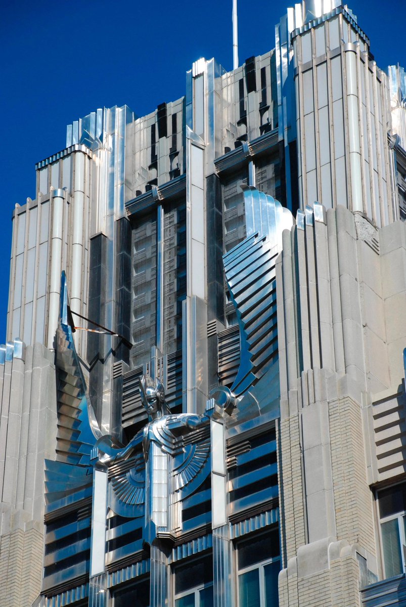 gietzschean's tweet photo. Art Deco actually made a power company building look exactly like a power company. 

The Niagara Mohawk Building in Syracuse was completed in 1932 as the headquarters of Niagara Hudson Power Corporation.

At night, concealed lights within the façade, illuminated glass panels, floodlighting on the central 'Spirit of Light' sculpture, reflective aluminum, polished glass and stainless steel turned the building into a glowing advertisement for the power of electricity in the age of machine. 

This also represented the optimism and beauty that could be incorporated into modernist structures.
