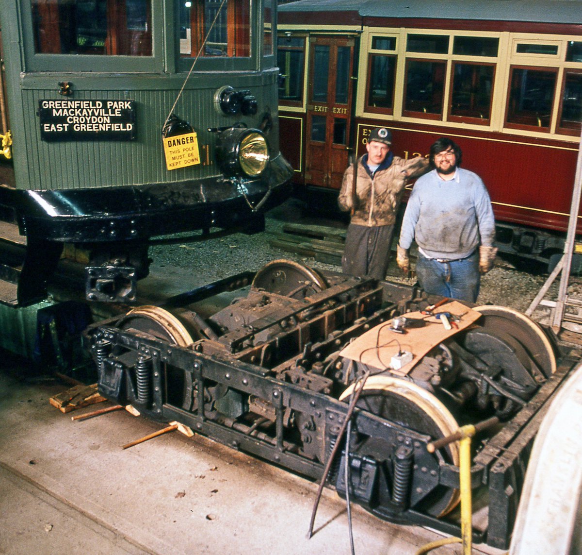 streetcarmuseum's tweet photo. Inside one of our museum's car barns on March 17th, 1991. The two men are Ian Smith and Patrick Lavallee, working on car #107's truck. Ron Cooper photo. https://t.co/3ykw53rH68