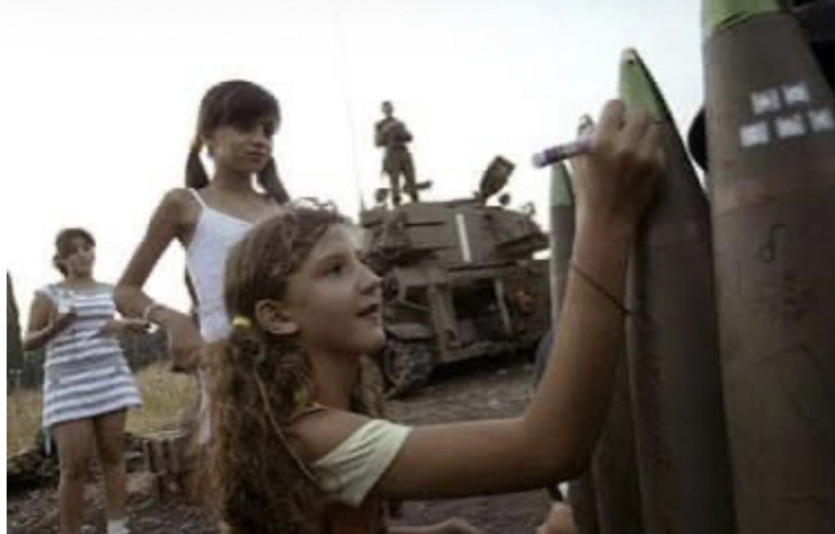 jakeshieldsajj's tweet photo. Here, a young Israeli child writes on a missile, mocking Palestinians who will be killed 

It's sad that children are taught to hate and enjoy the suffering of others based on race 

America is falling apart because all of our money is being sent to pay for this https://t.co/srx9159vSm