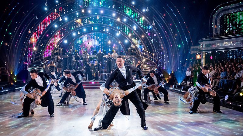 StrictlySparks's tweet photo. Week 1 songs, dances and pro routine
#Strictly 
Strictly 2026 Week One Song and Dance List

🪩Bethany & Nancy - Quickstep to Stop This Flame by Celeste

🪩Dani & Nikita - Samba to Lush Life by Zara Larsson

🪩Delta & Kai - Samba to Baianá by Barbatuques

🪩Jaime & Carlos - Tango to I Feel Love by Donna Summer

🪩 Lacey & Vito - Cha Cha to How Will I Know by Whitney Houston

🪩 Melanie & Aljaž - Cha Cha to Don’t Go Breaking My Heart by Elton John and Kiki Dee

🪩 Dame Sarah & Julian - Quickstep to C’est Magnifique by Kay Starr

🪩 Tabby & Mark - Jive to Animal by KATSEYE

🪩Cach & Maddie - Quickstep to I Just Might by Bruno Mars

🪩 Chris & Amy - Tango to No Roots by Alice Merton

🪩 Graeme & Lauren - Cha Cha to Hound Dog (Smokey Joe's Café version)

🪩 John & Katya - Foxtrot to Ordinary by Alex Warren

🪩 Lawrence & Jowita - Paso Doble to Aperture by Harry Styles

🪩Shaun & Alexis - Cha Cha to Lil Boo Thang by Paul Russell

🪩 Will & Dianne - Samba to Rock DJ by Robbie Williams

Ahead of the couples' ballroom debuts, the Strictly Professionals - plus the hosts and judges - open the show with a dazzling group number set to an epic orchestral version of Joy by RAYE.