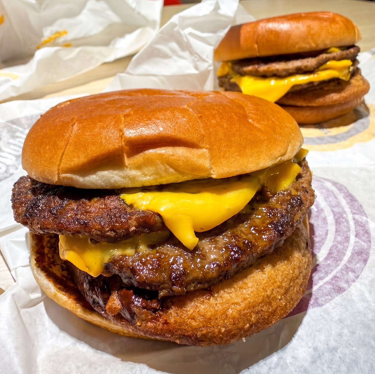 HuinGuillaume's tweet photo. Ok, I tried the viral menu hack called Cookie McDouble hack. This was a proper culinary odyssey so I feel the need to report in depth.

Look and Feel:
o  Surprisingly, the cookie blends pretty well with the rest of the burger. The dough color is close to the inside of the color of the bun, and the chocolate chips brings warm and depth colors not so different from the beef patties. For some it will feel a bit too much like a sea of sameness, but others will like its consistent look. If you look at it fast enough, it’s easy to miss the cookie in there. You may want to push it forward towards you, so you get more of it first bite.

o  The build is pretty balanced, so it stays in place quite easily.  The fact you must order it plain also helps with keeping everything together vs having the ketchup/mustard/onion making everything slide. It does not require holding the burger any different way you would do for a Double or Triple Cheeseburger, but I did inadvertently press the top bun a bit too strong when I assembled it.

Assembly:
o  Extremely easy to do if you put the cookie between the bottom bun and the first beef patty, or right below the top bun. In that regard, it’s pretty smart because ease of assembly matters so that it does not become too much of a barrier to try. There’s an alternate option putting the cookie between the two patties and this is where things get messy as you need to separate the two patties and they’re full of melted cheese. I am actually not sure I would recommend this, as you want the chocolate to be closer to the source of beef taste and to the source of warmth, so the chocolate can slightly melt.

o  I really, really recommend removing mustard, ketchup, onions. Regarding pickles, I tried but keeping them was not for me (it's the second burger in the back of the picture). I preferred without. But I am not necessarily the biggest fan of pickles anyway so I would not take that comment in consideration if you’re a pickle fanatic.

Overall taste:
o  It definitely feels like unknown territory when you get your first bite. There’s an additional gentle and quiet crunch mid-bite that feels different from the 100% softness you usually get from the juicy patty and melted cheese in the Double Cheeseburger.

o  I did not enjoy so much the “peripheral” bites or edge bites (I am sorry, I am not a native English speaker and I can’t find a better way to explain it). I guess it’s due to the fact these edge bites get more dough than chocolate. So, when and if you try it, I highly encourage pushing at least to the second bite to form your final opinion on the beast.

o  The second bite is bringing more chocolate notes forward. As it gets in contact with the warmth of the beef patty, it gets melty and deliciously soft, like if the cookie came straight from the oven. This is for me where the “magic” started to happen. But let me be clear: I would not say I was surprised by how much I liked it. I was definitely surprised by how much I liked it versus what I expected (I am going to be honest I thought I would hate it). I did some quick research and I see there’s actually a lot of expert literature around why chocolate and meat can be a powerful culinary match, which I ignored until today.

o  What was most interesting for me was probably not the taste itself (which is surely an “acquired taste”), but the feeling that I had never tasted anything quite like it before. Most hacks merge expected taste and texture together but this felt more like an entirely new creation. Uncharted territory, particularly for a French like me who grew up with more classical and expected combinations of taste and food.

Verdict:
Am I glad I tried it? Absolutely. Particularly because it was created by fans. Would I have it again? Unsure, but that's a personal preference. I was confused at first but now I get why people would/could like it.

On my side, I believe the only thing that can beat the original taste of a double cheeseburger is a triple cheeseburger. And there are just other hacks I have more appetite for, like the Crunchy Double (4 McNuggets with barbeque sauce under the patties of a Double Cheese), the hashbrown inside the Egg McMuffin and the other hack that I can’t say the name of.

That’s it. It was awesome to try. Sorry this was a long read. Don’t hesitate to send me your McDonald’s menu hacks, always happy to try.