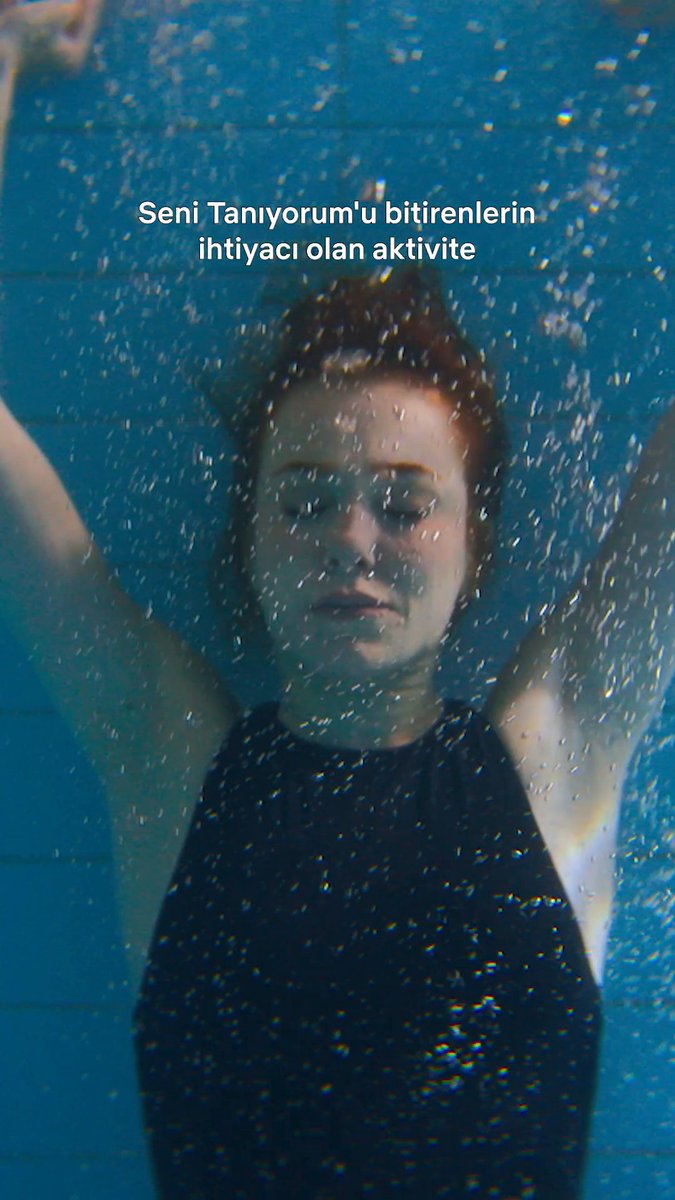 Underwater shot of a woman with her eyes closed and arms raised, surrounded by bubbles against a deep blue background. Turkish text overlay reads "Seni Tanıyorum'u bitirenlerin ihtiyacı olan aktivite" (translation: "The activity that those who finished watching 'Seni Tanıyorum' need"), referencing the Turkish drama hashtag #SeniTanıyorum and featuring actress #ElçinSangu.