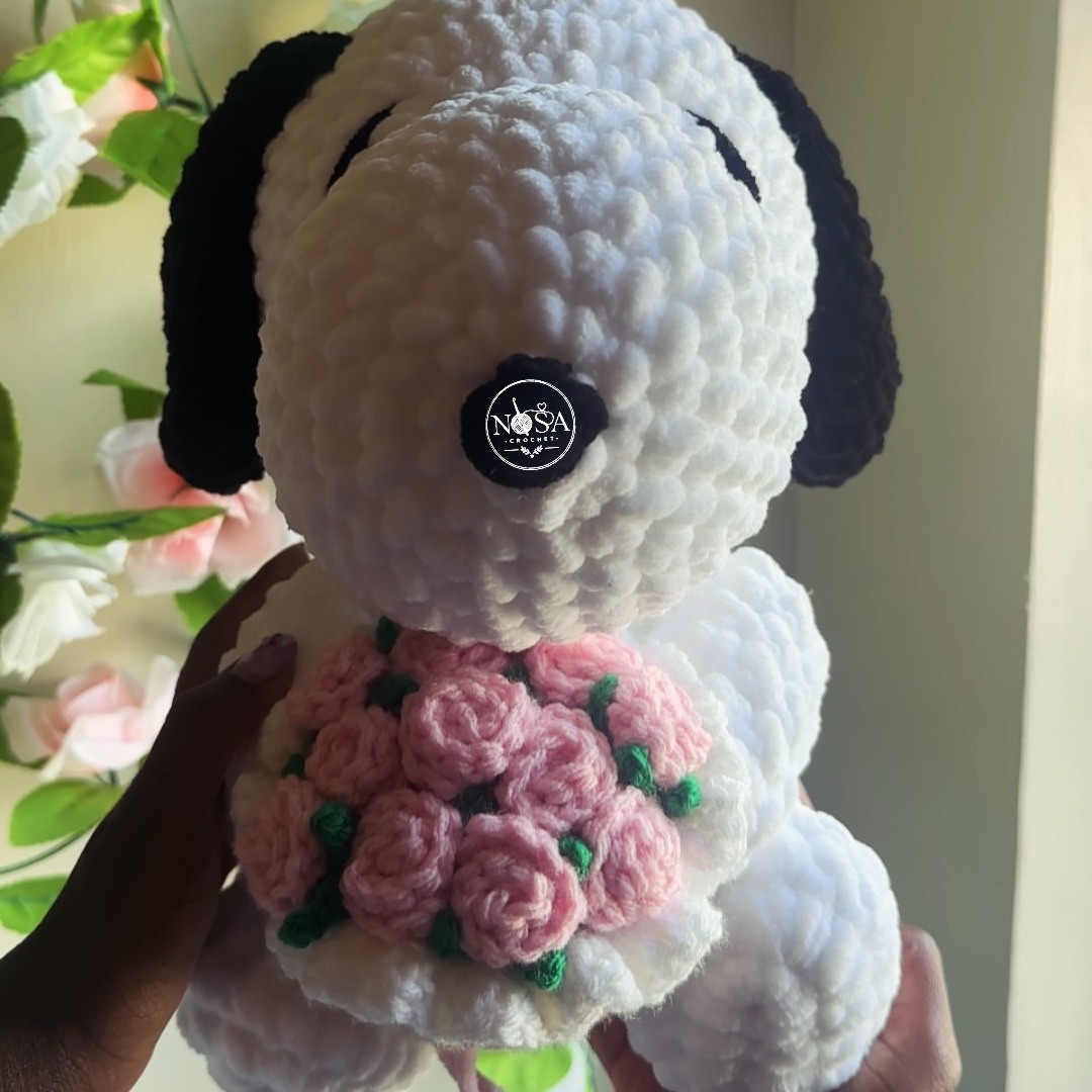 GrahamEiseck's tweet photo. Handcrafted with ultra-soft plush yarn, this crochet Snoopy holding pink roses is made to warm hearts. Custom orders are available, from baby booties and sweaters to home décor. Message us to reserve yours. https://t.co/yoveqcxm7T
