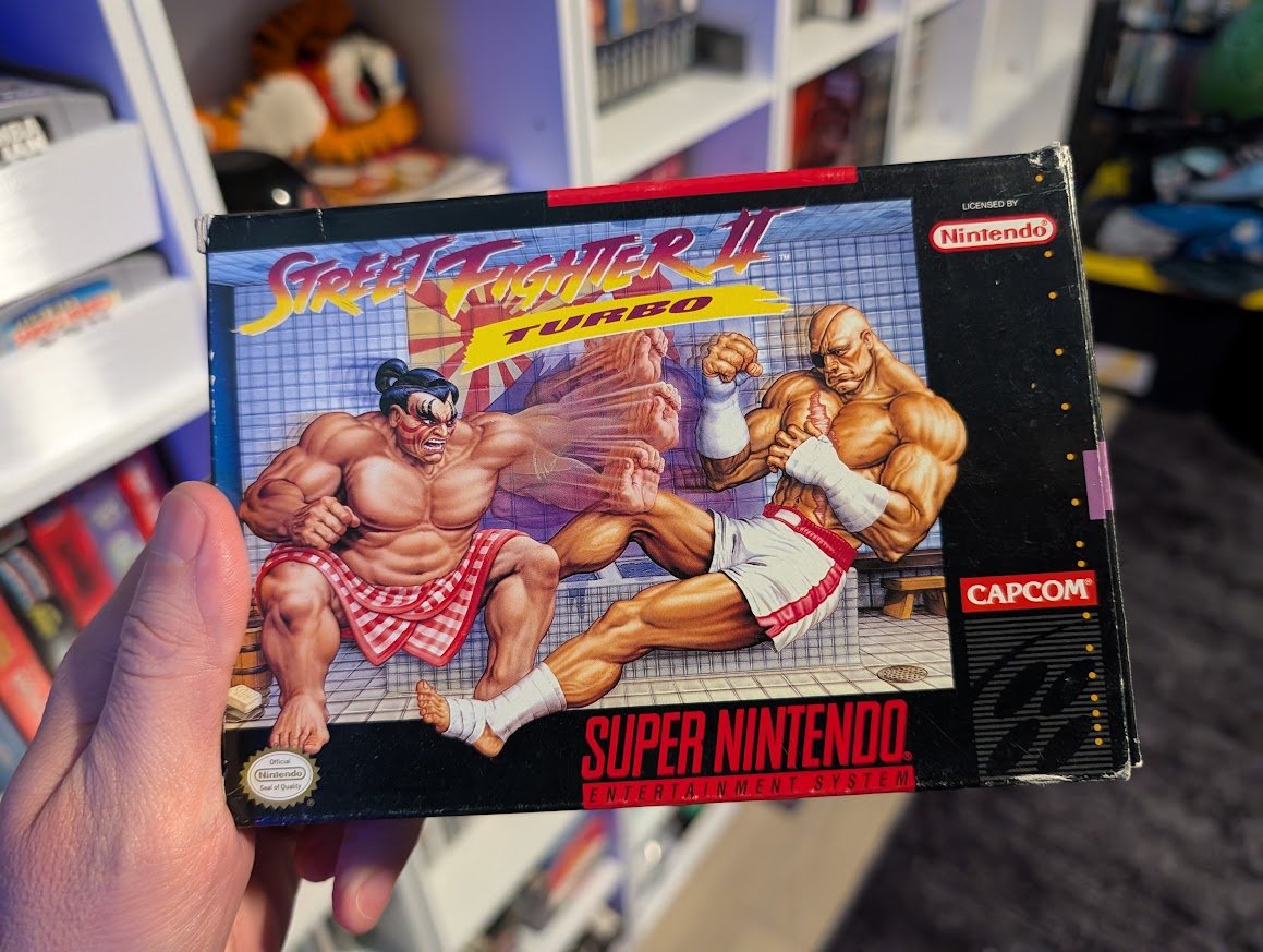 NostalgiaPro's tweet photo. Honest and Unpopular Reviews No. 50

Street Fighter II Turbo (SNES)

Everyone who played Street Fighter II as a kid had that one character they picked every single time.

Mine was Ryu.

I rented Street Fighter II from Blockbuster so many times that it would have been cheaper for my mom to just buy it.

This was a game everyone I knew had. Any time we went to a cousin's house or a friend's house, they had Street Fighter II Turbo.

I was 10 years old and my parents took us to a get-together at their friends' house. I was so bored. One of the kids asked me if I wanted to play Street Fighter. I asked him which one he had and he said Turbo. I got excited and we played for hours. I still remember that day vividly.

Turbo is the original Street Fighter II on steroids. You can play as Balrog, Vega, Sagat and M. Bison now, where before they were just the bosses you had to beat at the end.

Once you turn the stars up on the speed setting, it's a completely different game from the original. Everything moves so fast you barely have time to react to what the other guy is doing. Both players can finally pick Ryu now too, so you get Ryu against Ryu at full speed.

This is the best Street Fighter ever made and the best fighting game ever made. Nothing released in the 33 years since has knocked it out of the top spot for me, Mortal Kombat II and Tekken 3 included.

I rate Street Fighter II Turbo an astounding 5 out of 5.