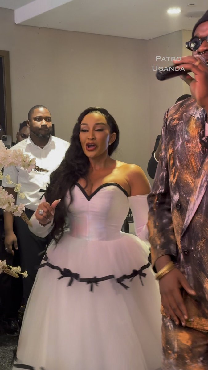 Zari Hassan, dressed in a stylish pink off-shoulder gown, is being escorted by Elijah Kitaka during her 46th birthday celebration. The watermark "Patro Uganda" is visible in the upper right corner.