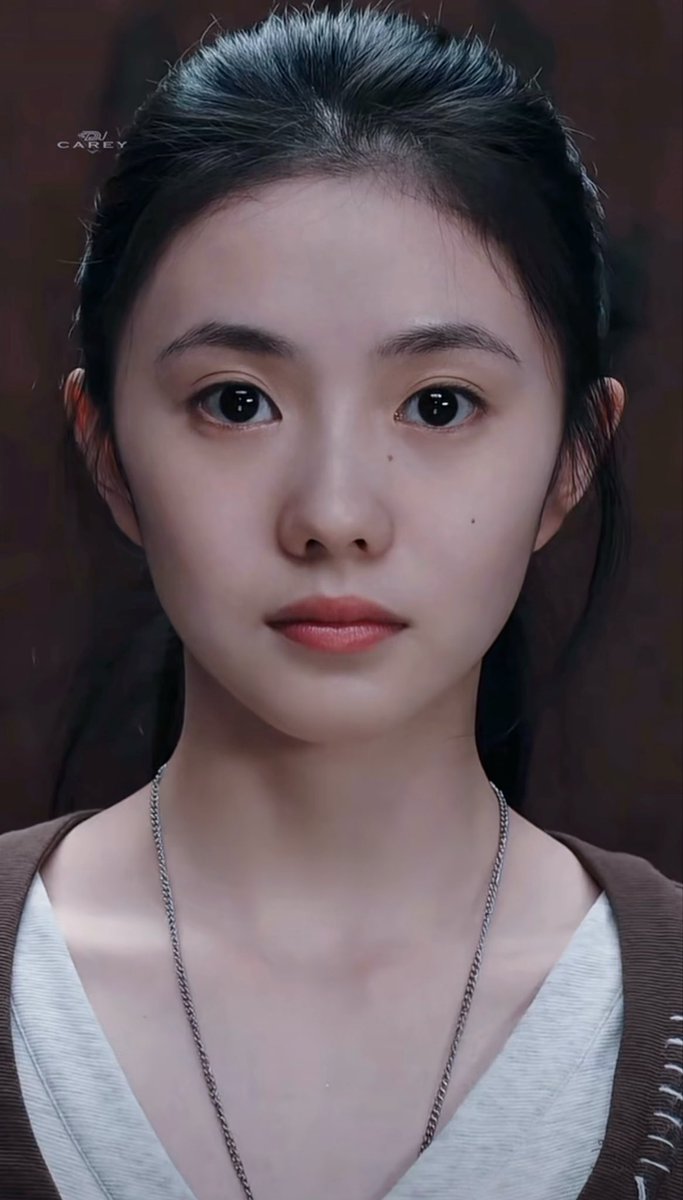 A detailed 3D-rendered portrait of a young woman with large eyes and a silver necklace, with a small 'CAREY' watermark visible.