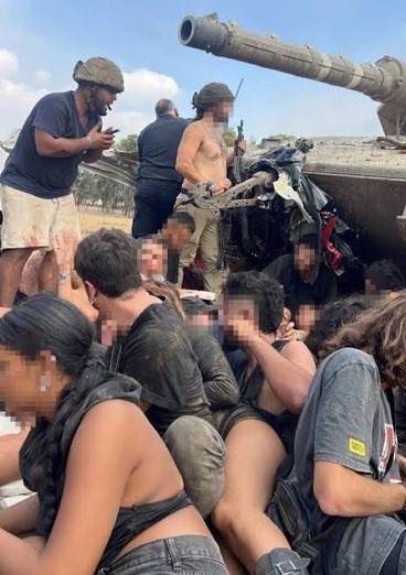 journo_ben's tweet photo. The two partygoers who found a tank and saved 30 lives.

Daniel and Neria Sharabi came to the Nova festival to dance.

Then the shooting started.

As Hamas terrorists stormed the festival, the brothers ran for their lives. A pickup truck of terrorists opened fire. An RPG hit a vehicle near them. In the chaos, they were separated from one of their friends, who was later taken hostage.

They kept running.

About half a kilometer from the festival, they reached a damaged Israeli tank.

Around 30 people were already taking cover there, terrified partygoers, wounded civilians and police officers.

Daniel and Neria were former combat soldiers.
But they knew almost nothing about tanks.

So Daniel called Yoni, an army officer he knew from his military service.

Yoni knew what to do.

With Yoni guiding them over the phone, the brothers climbed into the tank, searched for weapons and ammunition, put on combat helmets and began figuring out how to defend everyone around them.

Then they took command.

They organized the people around the tank, cared for the wounded and turned the disabled vehicle into a defensive position.

When terrorists advanced toward them, the brothers opened fire.

Again and again.

For hours, with very little ammunition, they held their position under gunfire and RPG attacks while Yoni continued guiding them remotely.

That morning, two guys who had come to dance at a music festival found themselves commanding a battlefield from a broken tank.

Around 30 people survived because of them.

Daniel was later chosen to light Israel’s Independence Day torch, representing the heroism of both brothers

#October7Heroes