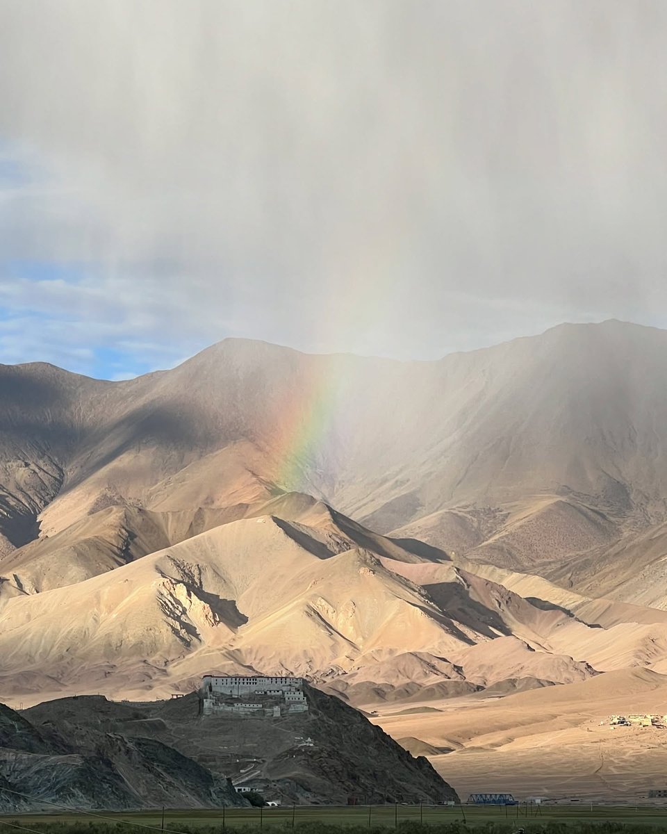 Anki_an7's tweet photo. Nature’s wonderful surprises captured perfectly: a stunning rainbow welcomed us back to Hanle village after summiting Umling La and Photi La. Hanle Palace stands beneath the rainbow. https://t.co/S87KfLJ9on