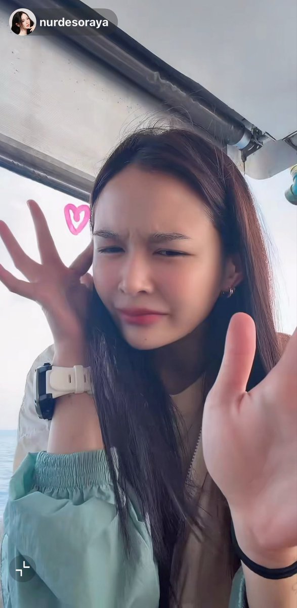 An Instagram story screenshot from user 'nurdesoraya' shows a young woman making a silly, scrunched-up face with her hands raised on a boat.