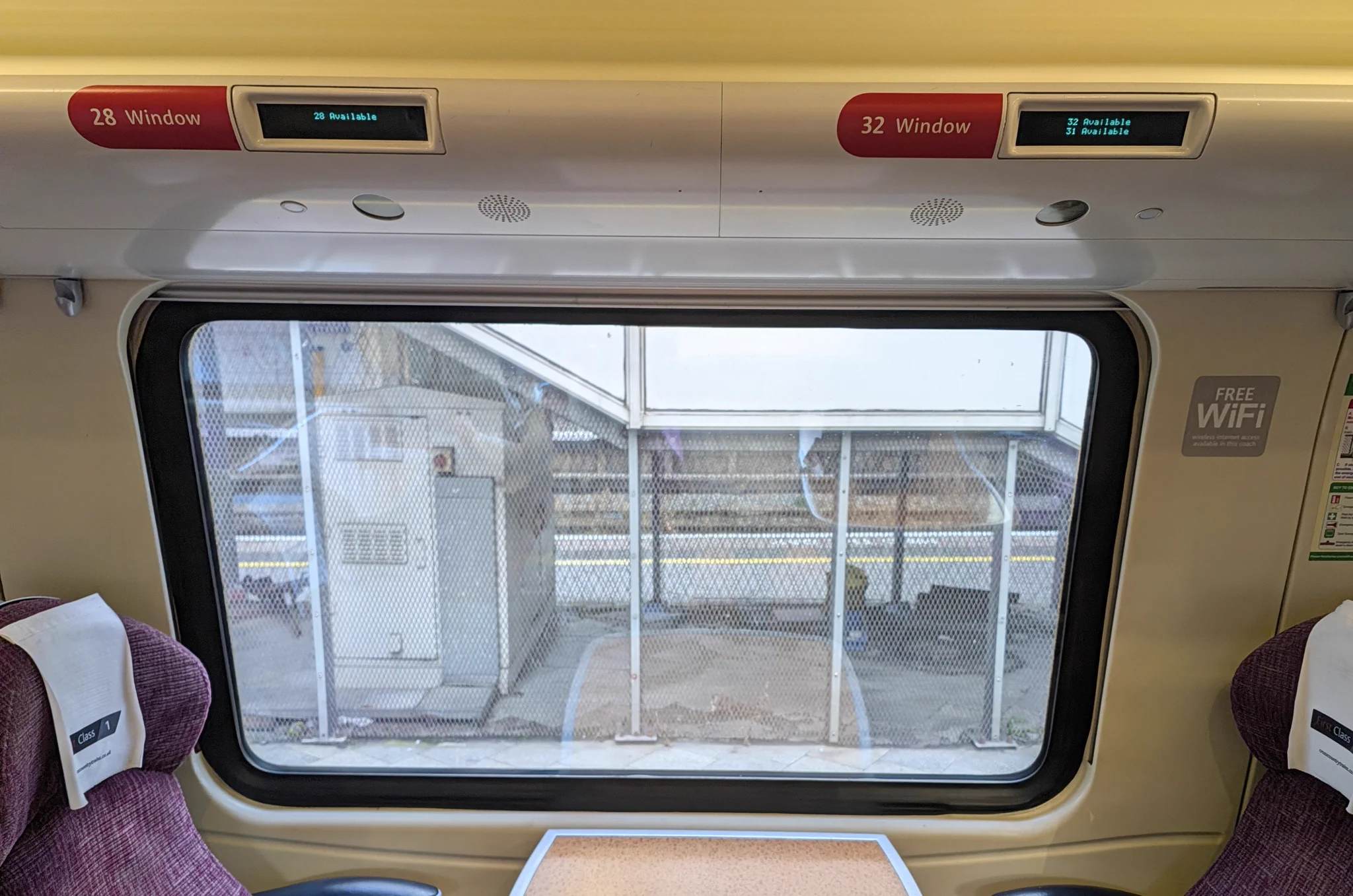 A photo of two CrossCountry seats around a table in First Class. Reservation screens above them list 3 seats: 28 and 32 (the real seats) and an additional Seat 31 which does not exist.