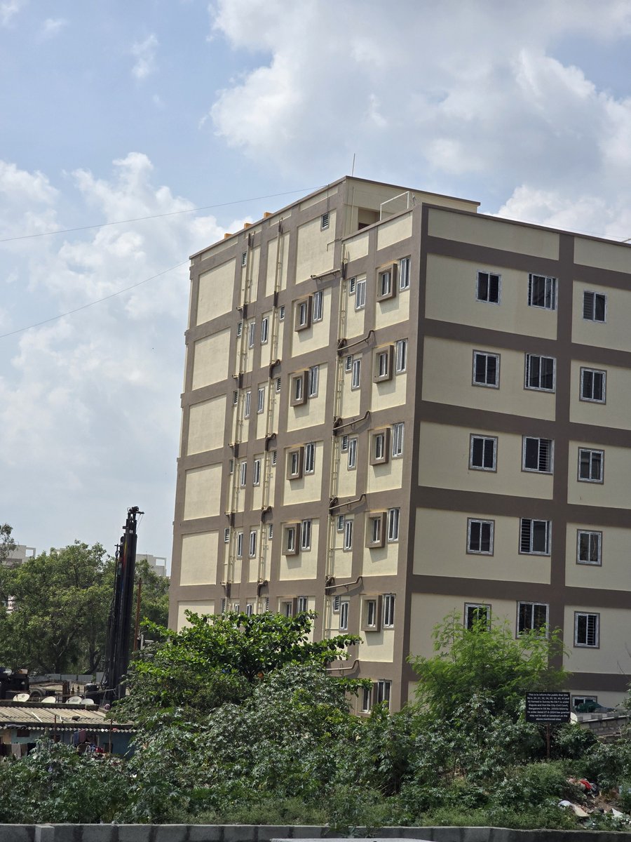 Gems_of_blr's tweet photo. Bengaluru’s master plan: cram 6 multi-storey PGs on one tiny street, drill 12 borewells straight into the Earth's core, and pray for water tankers when the aquifer goes bone dry.

​Zero municipal water, zero underground drainage, but 24/7 deafening drilling noise guaranteed.
​And the civic norms? Dump sand, gravel, and bricks right in the middle of the road, let 20-ton RMC trucks crush whatever asphalt is left, and leave residents to choke on cement dust. Who needs livable cities when babus can just approve anything for the right price? 👏

Location: Chinnapanahalli but applicable to everywhere.

​@DKShivakumar @GBAChiefComm @BECCUPDATES @bwssbchairman