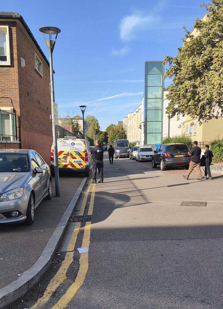 BICWO2014's tweet photo. PCM contractors washing sprayed parking signs and ticketing illegally parked cars this morning, a welcome sight. But what about the unregistered dumped car that’s been left on the estate? @HarcaPoplar, will this be investigated and removed? #BurdettEstate #ParkingEnforcement https://t.co/YFUTRhKcY7