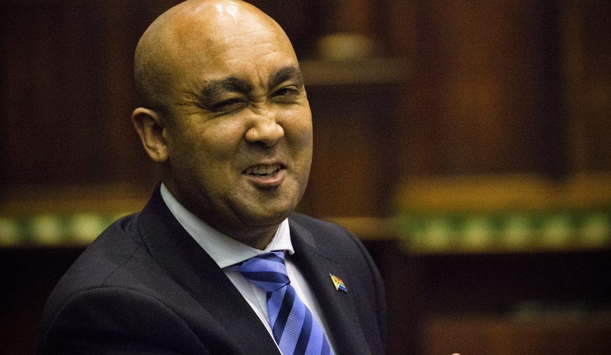 D_Molatoli's tweet photo. Chair Madlanga had that  smile the first time Joe Sibanyoni came with Advocate Shaun Abrahams as his Counsel to the Commission. They knew each other from Chair's days at the Constitutional Court. 😊 Chair's Judgement removed him as the National Director of Public Prosecutions. 
 
✅️  Justice Mbuyiseli Madlanga is the one who wrote and delivered the Constitutional Court Judgement in 2018, that declared the appointment of Adv. Abrahams as NDPP, replacing Adv. Mxolisi Nxasana, as invalid and unconstitutional. 

✅️ Madlanga ruled that former President Jacob Zuma abused his powers by "buying out" Nxasana with a R17.1 million golden handshake payout, and employed Abrahams. 

✅️ Madlanga also ruled that Nxasana's removal was unlawful, and no genuine vacancy existed to be filled by Abrahams. He was instead a beneficiary of abuse of power. He was ordered to vacate the position immediately.

✅️ Nxasana was not reinstated, since the environment was deemed chaotic. He was however  ordered to pay the R17.1 million, minus tax. 

✅️ The Presidency was given 90 days by the court to appoint the new NDPP.

So Chair looked at him and was like ohk, this is you Counsel. 😅
#MadlangaCommission