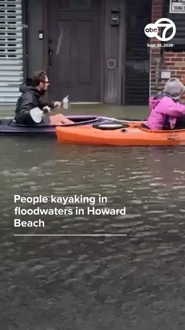 ABC7 news clip dated Sept. 26, 2026 showing people kayaking in floodwaters in Howard Beach, with water covering the street.