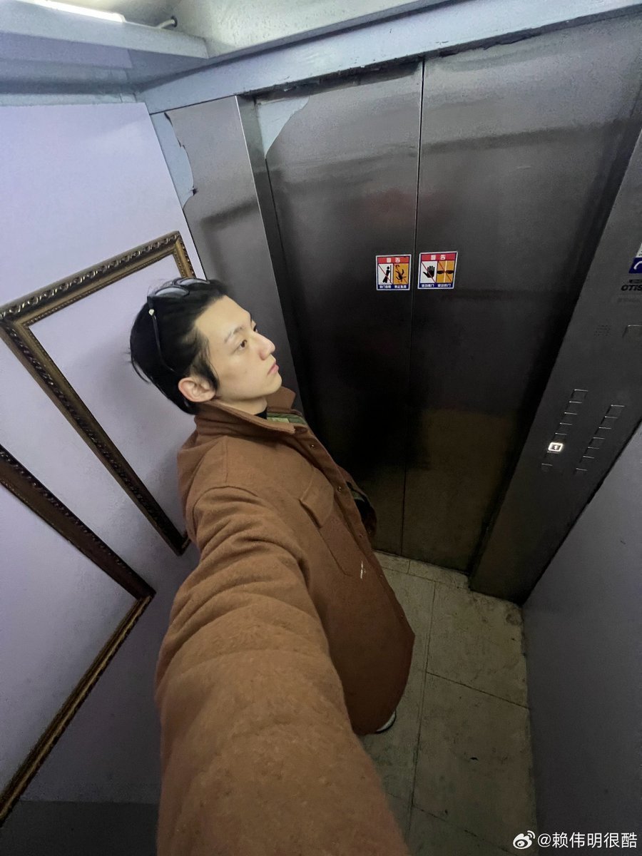 Wieiming's tweet photo. Waiting for the elevator to take me wherever it’s heading, letting my mind wander off while I stare at the metal doors. Wearing my favorite coat today and honestly just trying to keep my own peace in the middle of a chaotic week. https://t.co/XPCY3bzSAh