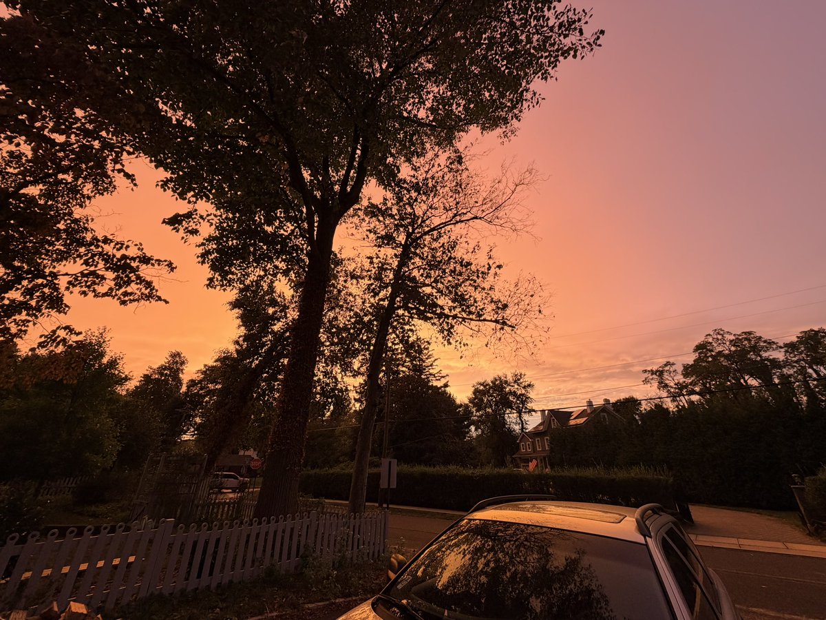 nasin's tweet photo. Friday evening as the nor’easter approached, we were watching TV and suddenly all the windows facing west filled with bright orange light. It was creepy and beautiful.

We went outside. The clouds in the west were acting like a giant reflector, spreading warm light from the setting sun across the sky.

Meanwhile, rain was already falling to the east, so the same setting sun was producing rainbows in the backyard!