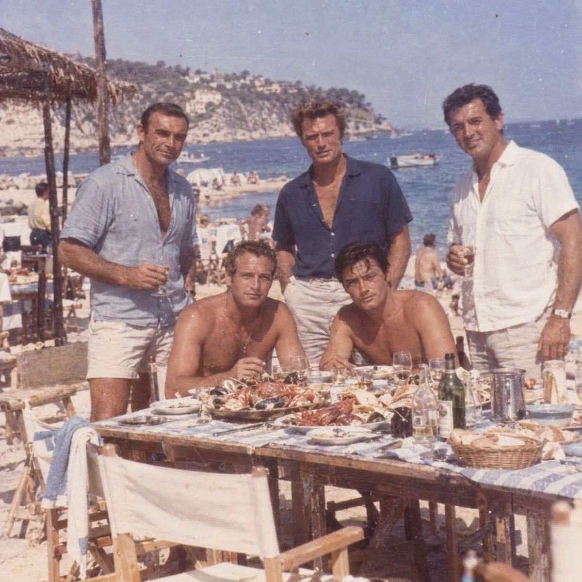 unlesswespeakup's tweet photo. @PCIPRESS_BKD @iamsrk @gaurikhan Paul Newman and Alain Delon, seated at a table laden with seafood, while Sean Connery, Clint Eastwood, and Rock Hudson stand nearby. - there are no beards, anabolic "muscles," moronic hairstyles botox or facelift @iamsrk &amp; @gaurikhan https://t.co/vs5qDd6DXf
