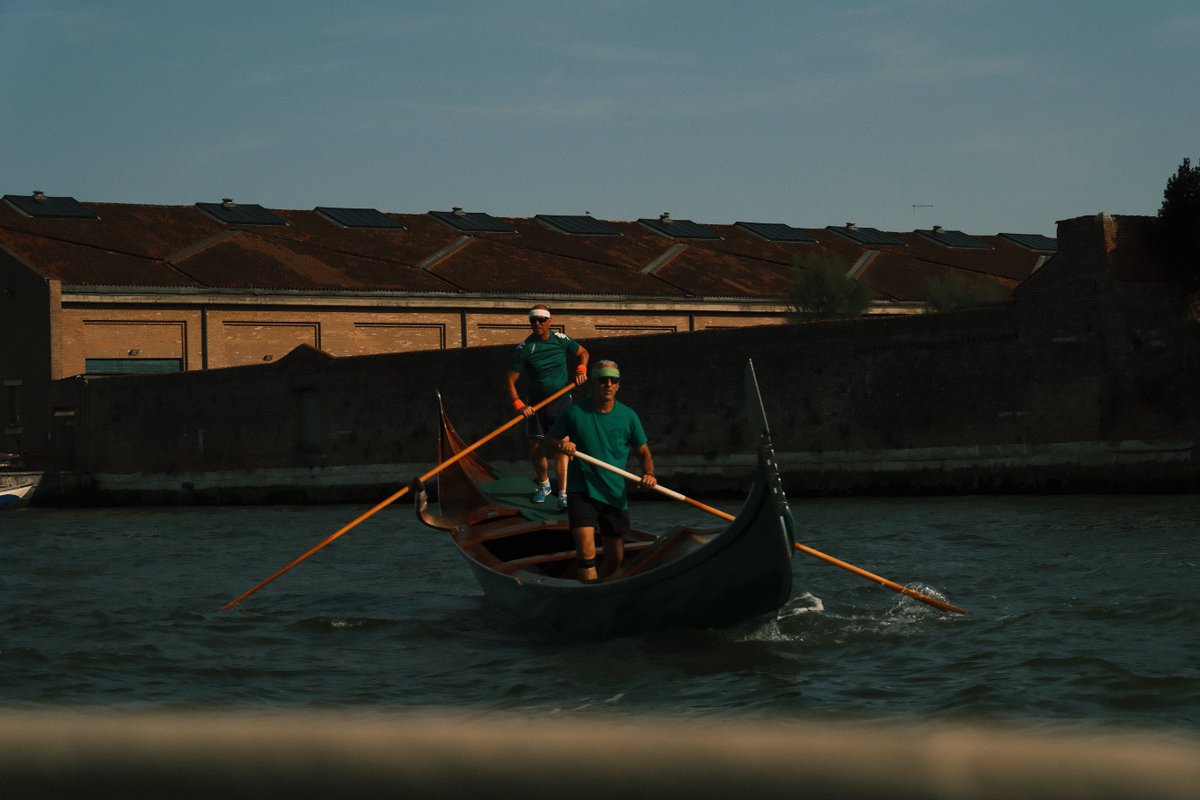 KarolLeemafa's tweet photo. People on the boat leave the safe canal and venture into rough seas with glass-like waves. At the end of Venice’s waterways, two solemn figures row in silence. Crossing the restless water begins by taking hold of the oars with your own strength. https://t.co/VuViJaoRcG