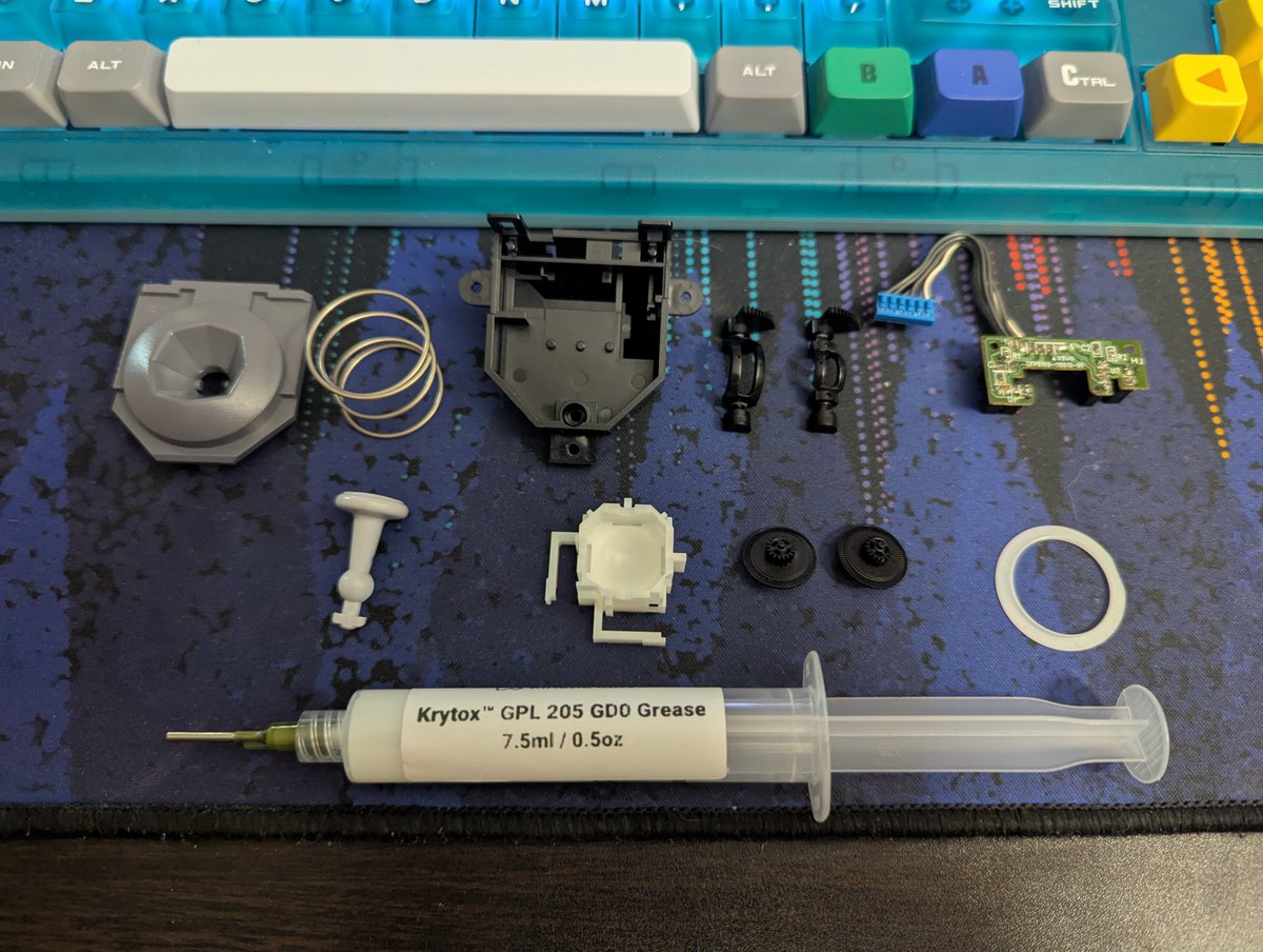 gamrjerome's tweet photo. The module in the gold controller was very clean. The first photo is when I opening it up. I still went though and cleaned all the parts. Lubed with Krytox GLP205. This module will stay OEM. I'll build different one for this controller. I added some #Bones64 Mewtwo buttons https://t.co/XMOb9LS4Up