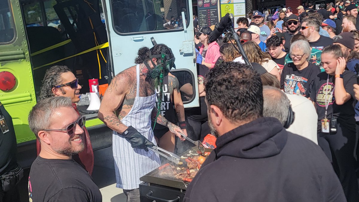 Emoney1937's tweet photo. Just when I think I've seen it all. There is a dinosaur working the grill. 😂

AEW Block Party is cooking! 🔥 https://t.co/9KTWVzegD3