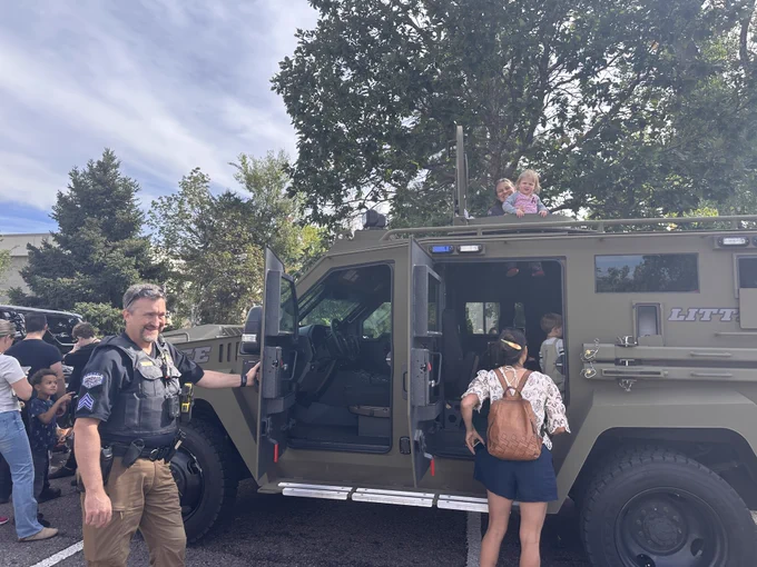 Kids with a police vehicle