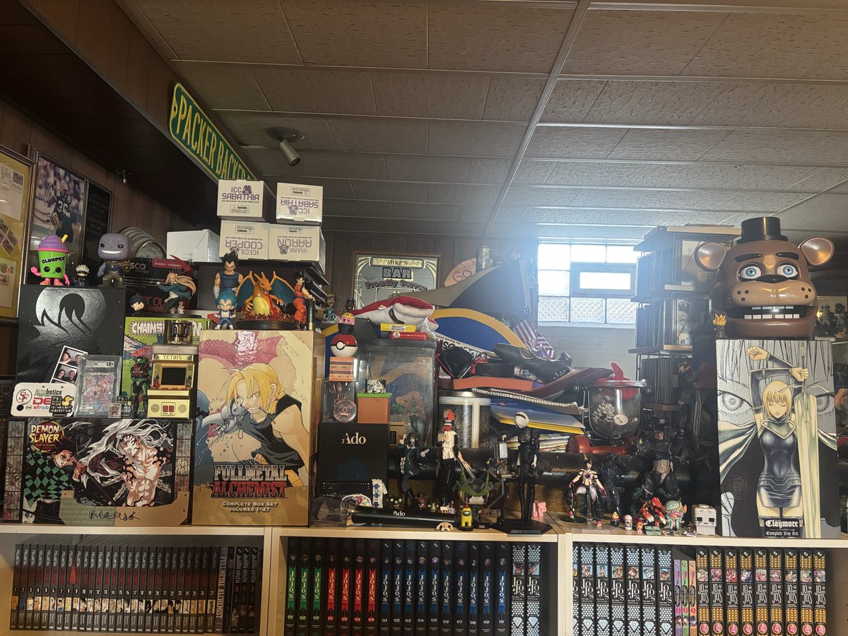 JTherealgerman's tweet photo. Here is what the shelf’s look like after I moved the stuff on top around. I need another bookshelf 👀🤔. https://t.co/t759hHBLOb