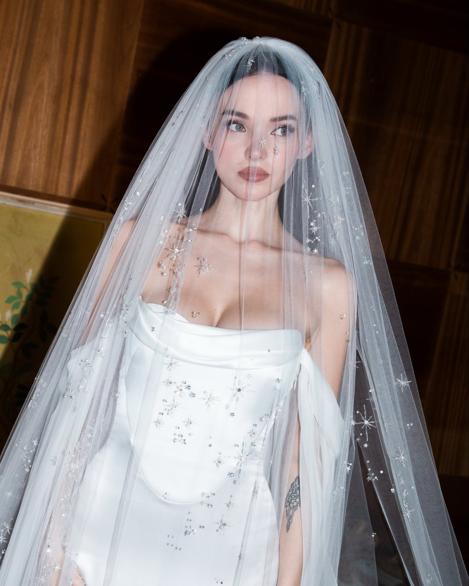 MaisonValentino's tweet photo. A custom-made Valentino wedding gown for #DoveCameron. 

From the first drape to the final silk-covered button, the making of Dove Cameron’s Valentino gown for her wedding to #DamianoDavid brings a singular vision to life in luminous silk satin and layers of weightless silk chiffon.