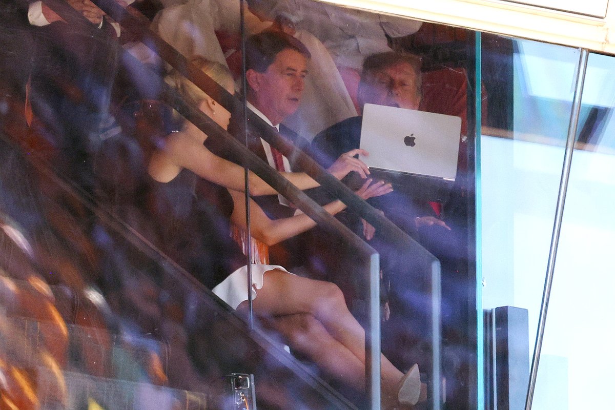 atrupar's tweet photo. Sen. Bill Hagerty and Trump have mouths agape as personal assistant to the president Natalie Harp displays something to them on a laptop during the Texas-Tennessee football game today 

(Tom Brenner/Getty) https://t.co/R6yCww0Emr