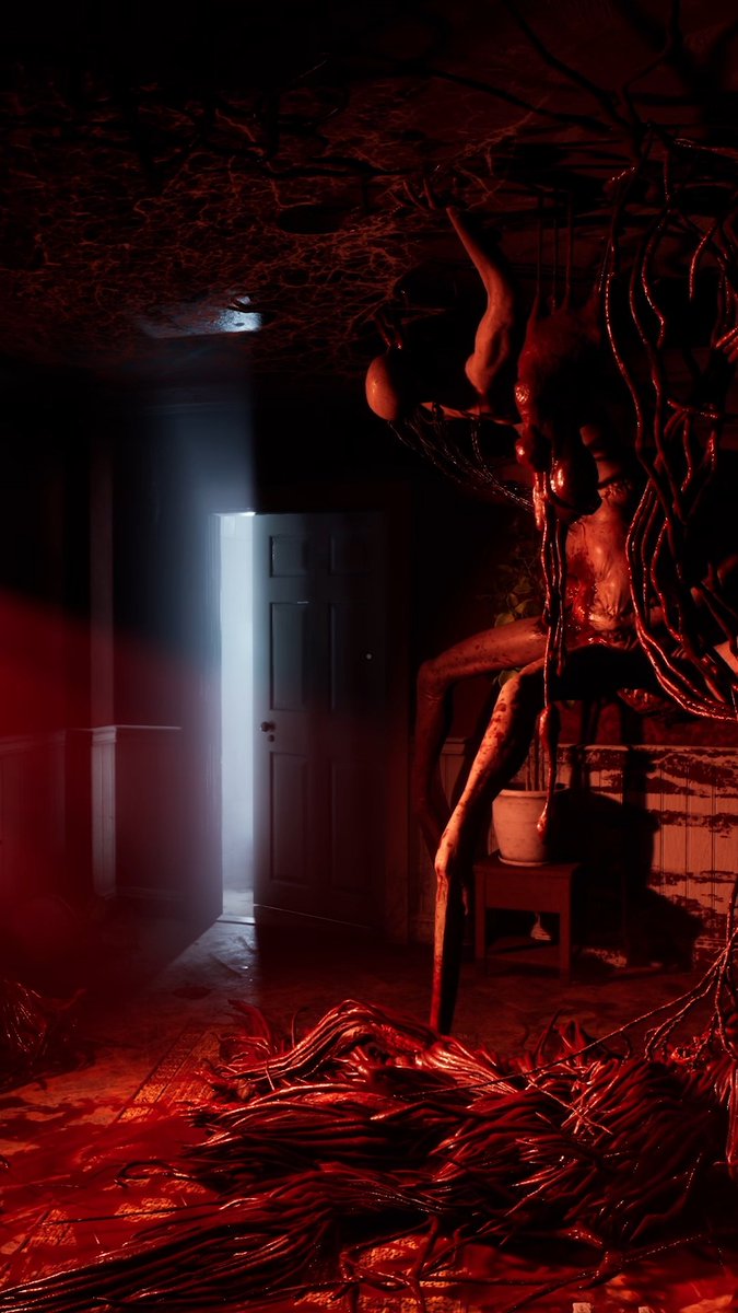 A dimly lit, blood-soaked hallway reveals a grotesque, elongated humanoid creature suspended from the ceiling by dark tendrils, with a bright doorway glowing in the background—an unsettling scene that invites viewers to "explore carefully" into the nightmare.