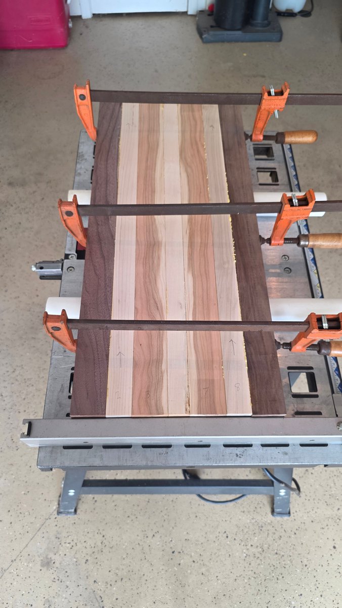 GDWorkbench's tweet photo. A large hardwood cutting-board panel is clamped up while the glue cures—an essential step before routing, sanding, and final shaping. Project GD-P-254: https://t.co/2BEW8Y70qI #GDWorkbench #WorkInProgress https://t.co/x2uXwlQeFv