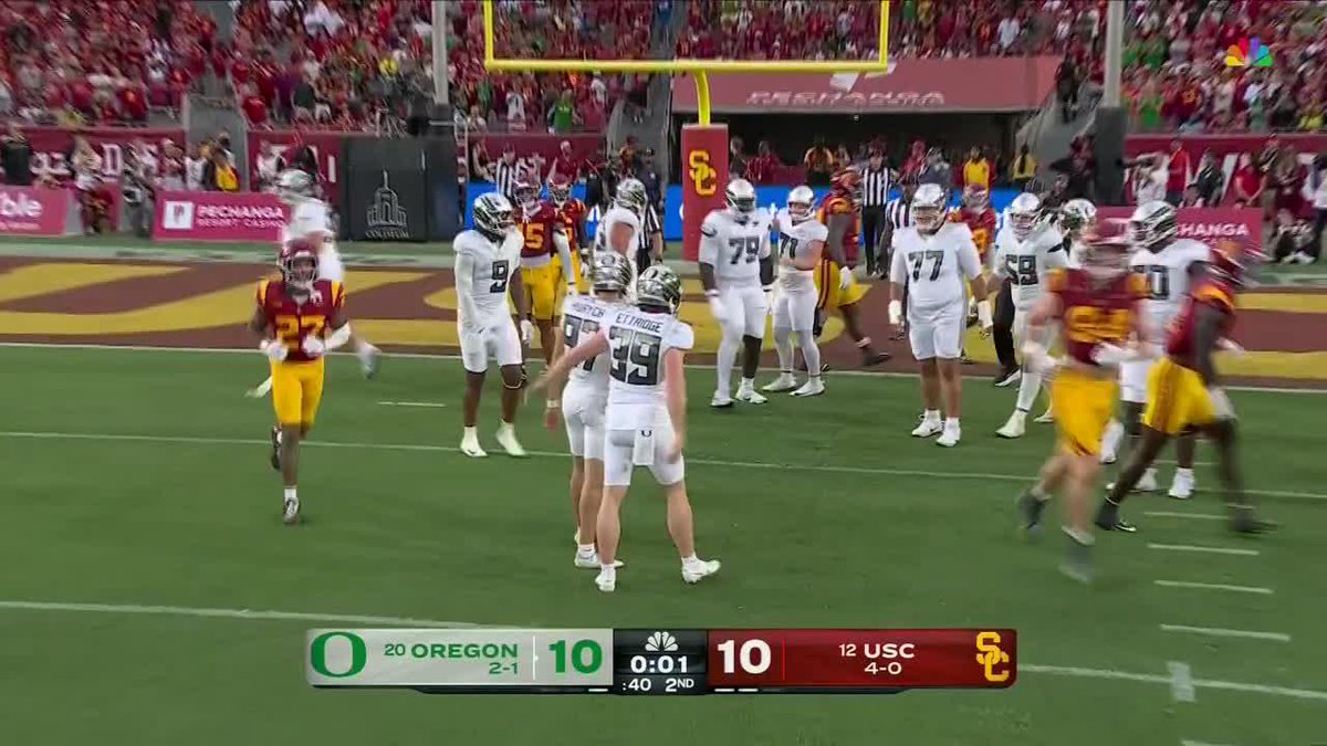 Oregon placekicker Gage Hurych (jersey #99) celebrates after kicking a field goal that gives Oregon a 10-7 lead over USC with just 0:01 remaining in the 2nd quarter, as shown on the NBC broadcast scoreboard at the LA Memorial Coliseum.