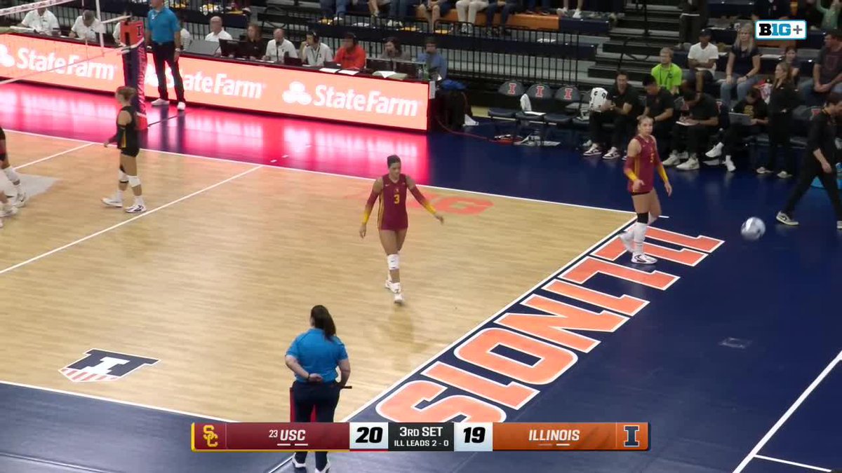 A women's volleyball match between USC (in red) and Illinois at State Farm Center, with the scoreboard showing USC leading Illinois 20-19 in the 3rd set.