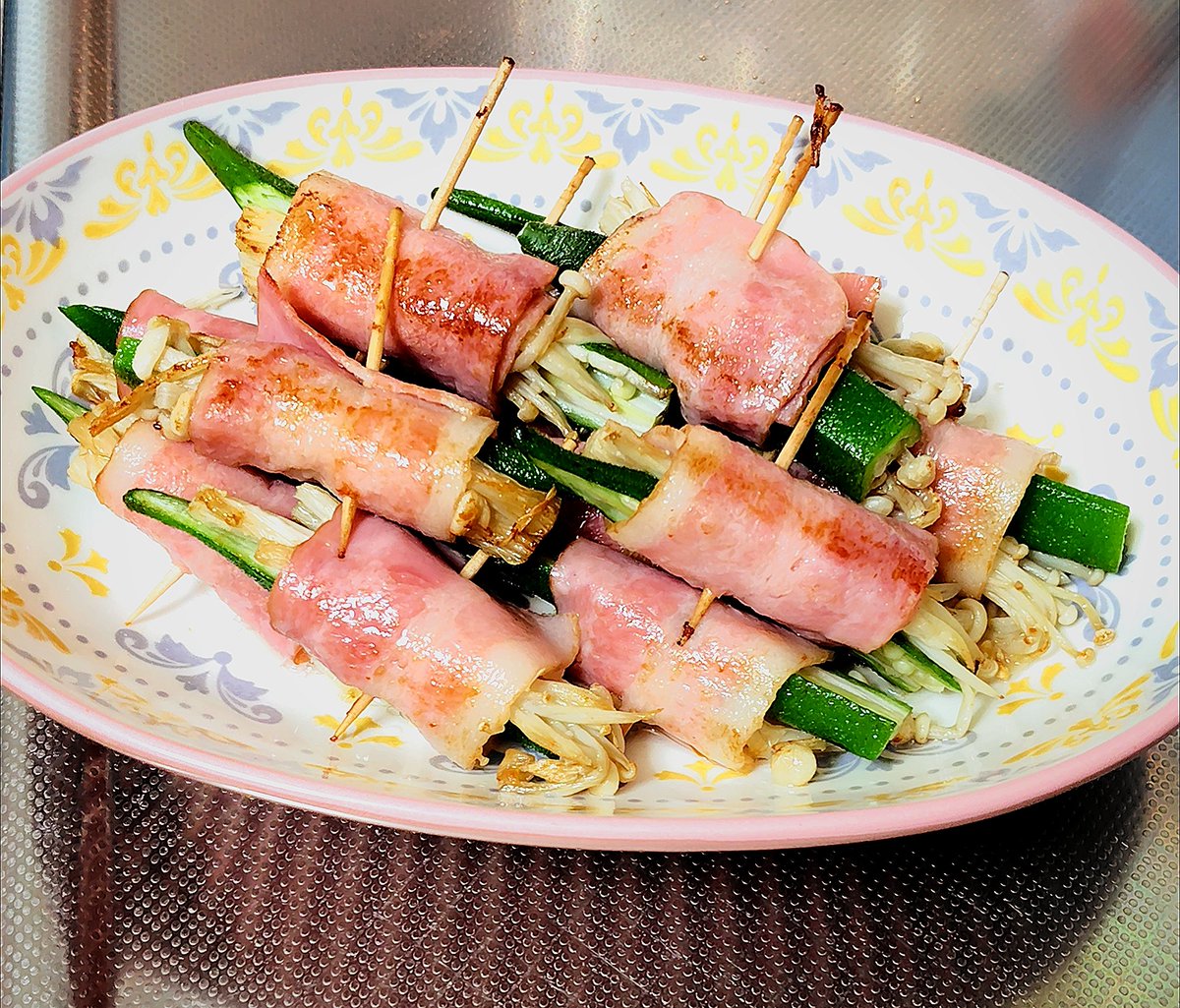 takbu315's tweet photo. えのきとオクラをベーコンで包んで素焼きしてみました🥓
ベーコンの塩っけがベースにあるのでこのままでどうぞ😊
どーしても足りない人はニンニクとか生姜を添えてね🧄
 #料理写真 
 #おうちごはん
 #家庭料理
 #うまい飯  
 #Japanfood https://t.co/xDOdpgrCml