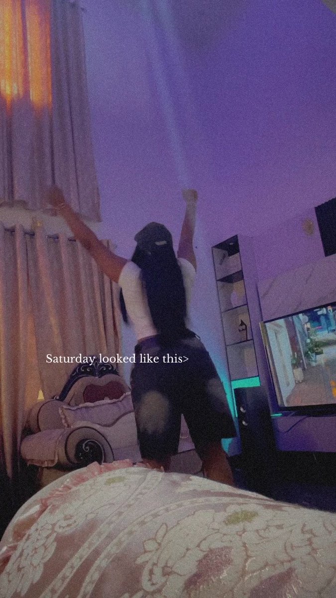 A woman stands in a room with her arms raised in front of a TV screen, with the caption 'Saturday looked like this>' overlaid on the image.