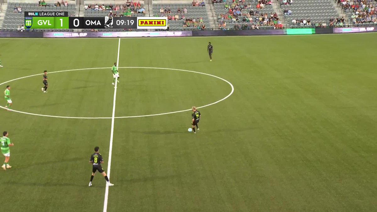 A soccer match screenshot from USL League One showing GVL leading OMA 1-0 at 09:19, with players in green/white and black uniforms positioned around the center circle of the field.