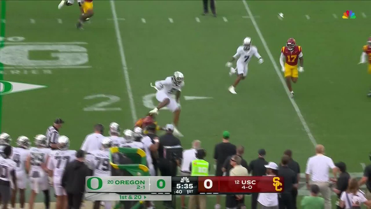 An NBC broadcast of a college football game between #20 Oregon (2-1) and #12 USC (4-0), tied 0-0 with 5:35 remaining in the 1st quarter on 1st & 20.
