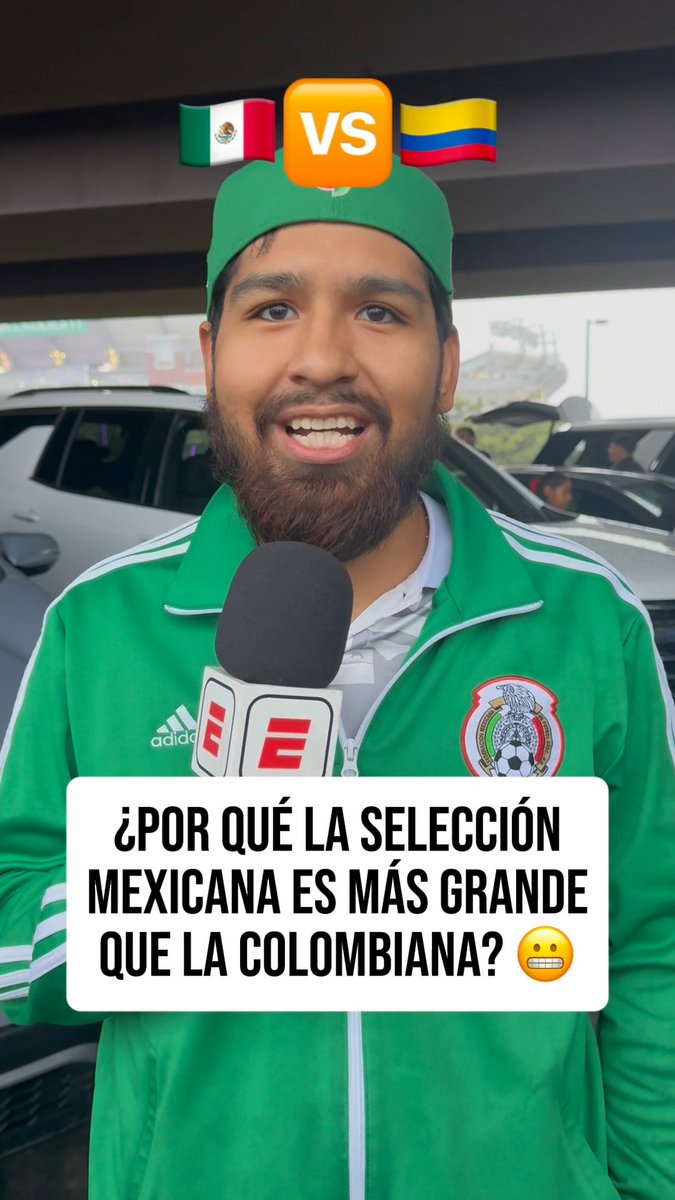 The image shows a fan wearing a green Mexico national team jacket and cap, with Mexican and Colombian flags displayed above his head separated by a "VS" graphic, holding an ESPN microphone while the caption reads "¿POR QUÉ LA SELECCIÓN MEXICANA ES MÁS GRANDE QUE LA COLOMBIANA?" (Why is the Mexican national team greater than the Colombian one?) — directly illustrating the post about Mexican fans explaining why "El TRI" is greater than Colombia, with his "simply for being Mexico" response capturing the patriotic sentiment.