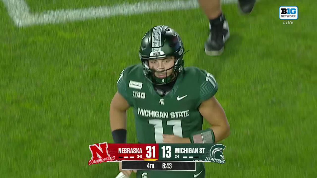 Michigan State quarterback #11 looks visibly frustrated during the 4th quarter with 6:43 remaining, trailing Nebraska 31-13 on Big Ten Network, moments after Andrew Marshall's interception sealed the Spartans' fate.