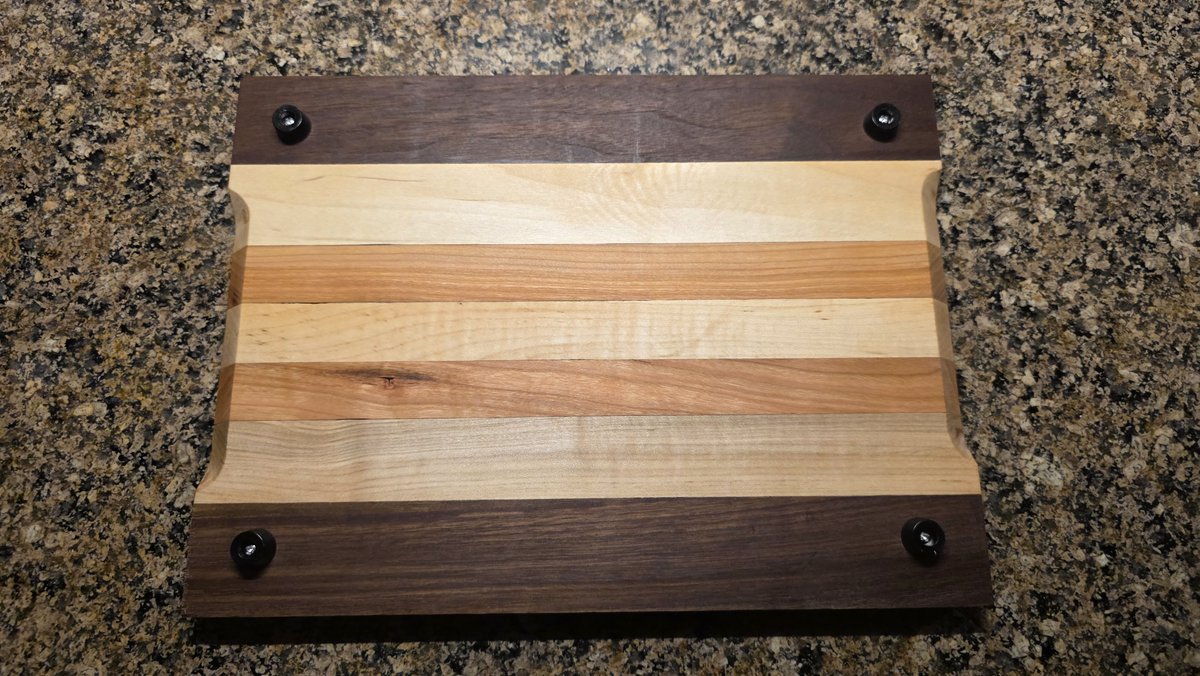 GDWorkbench's tweet photo. Walnut rails, lighter center strips, and four rubber feet finish the underside of this face-grain prep/cutting board, adding grip and airflow. Project GD-P-329: https://t.co/XFfiUpBA3s #GDWorkbench #CuttingBoard https://t.co/lhGQOLaHzt