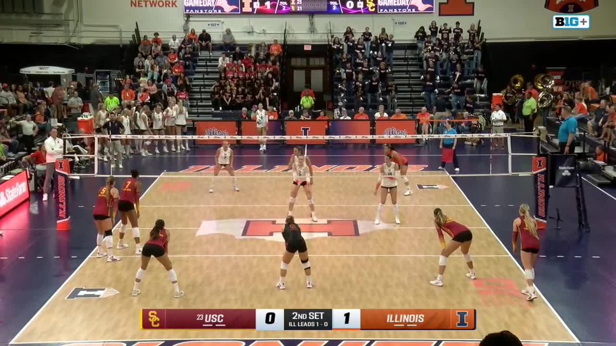 A women's college volleyball match between USC and Illinois during the 2nd set, with Illinois leading 1-0.