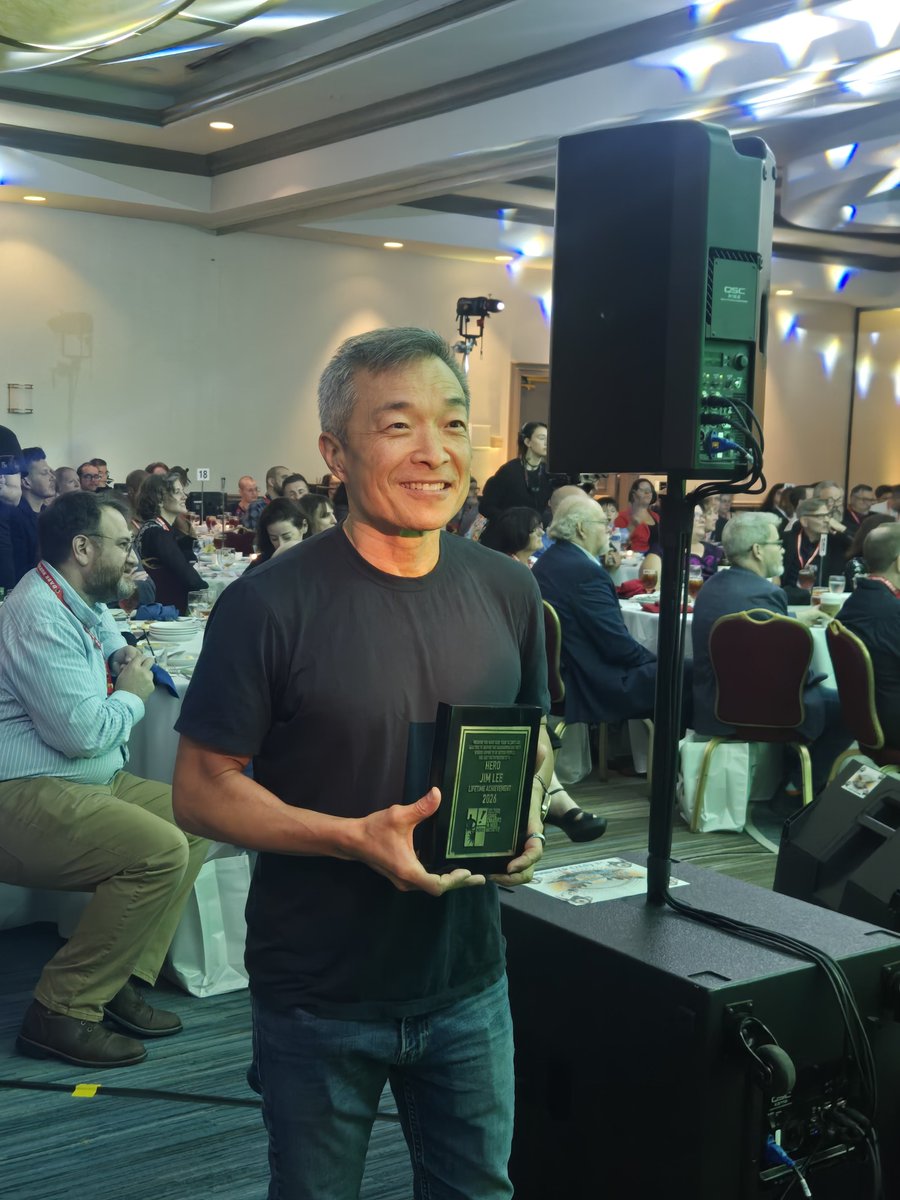 heroinitiative's tweet photo. Congratulations to @JimLee, recipient of the Hero Initiative Lifetime Achievement Award! @sdunbier presented him with the honor tonight at the @ringoawards during @baltimorecomics. Please join us in celebrating Jim! #BeTheHero #BCC2026

#BeTheHero #BCC2026 https://t.co/bik8DIjibI