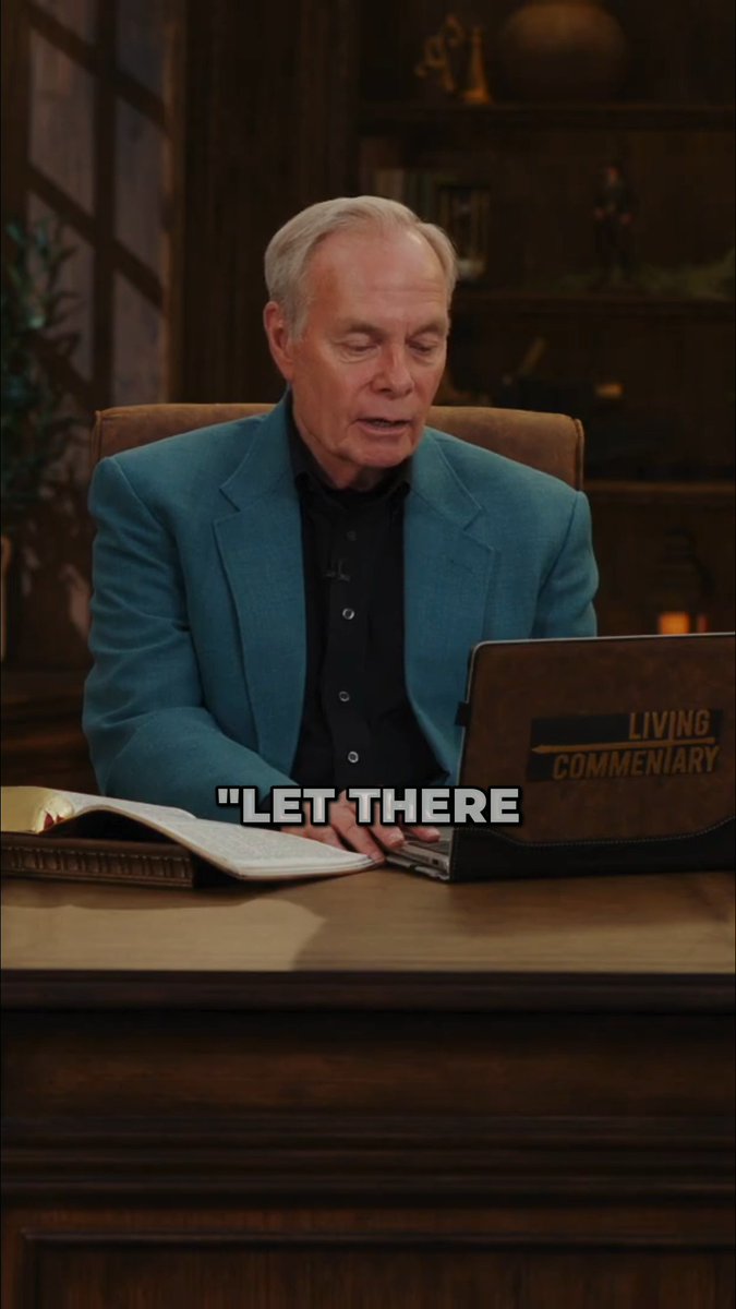 A man in a teal blazer sits at a wooden desk with an open Bible and a laptop labeled "LIVING COMMENTARY," with the subtitle "LET THERE" displayed across the screen.