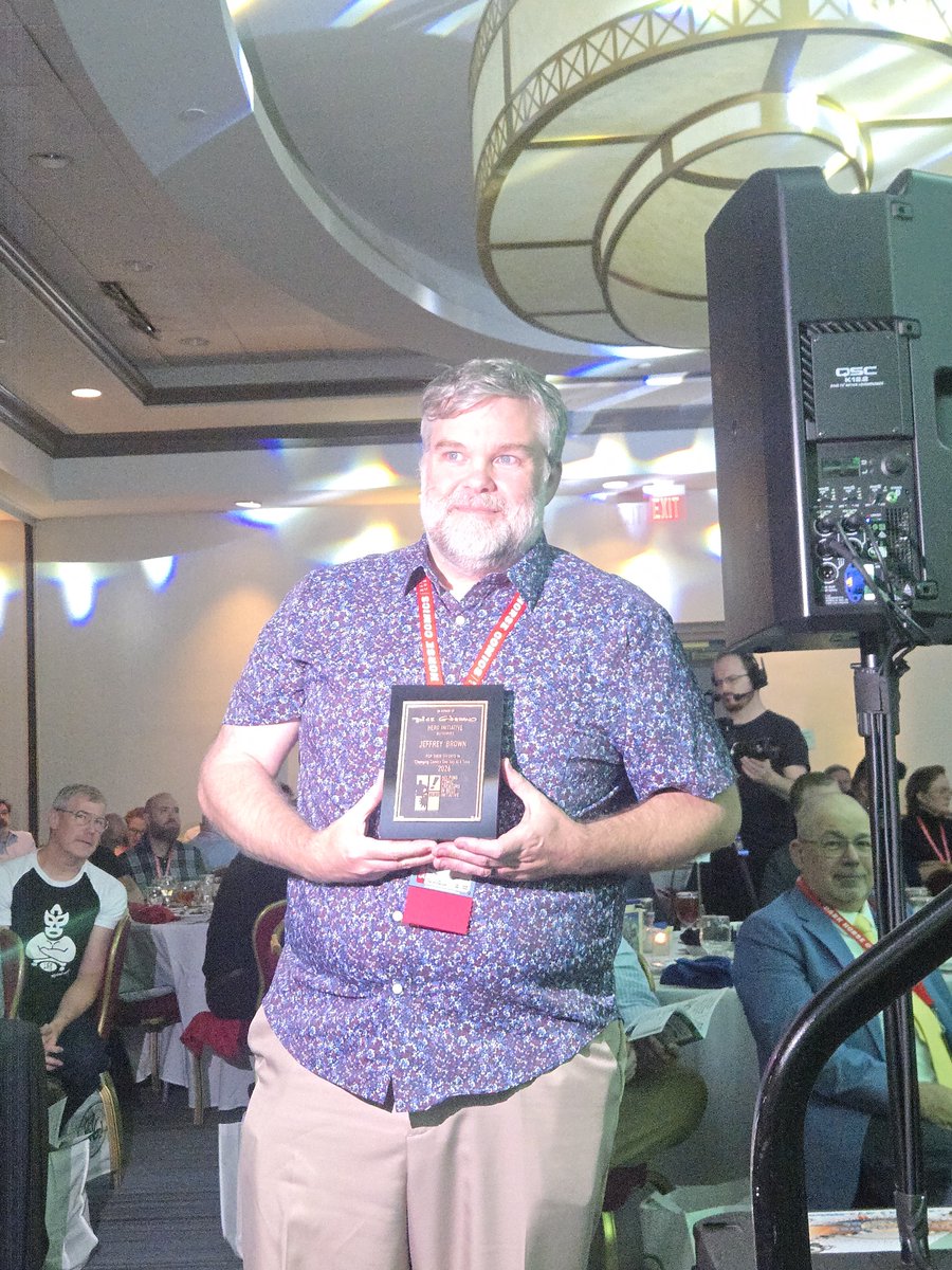 heroinitiative's tweet photo. Congratulations to Jeffrey Brown, recipient of the Dick Giordano Humanitarian of the Year Award! @GeneHa presented him with the honor tonight at the @ringoawards during @baltimorecomics. Thank you, Jeffrey, for showing up for the comics community. #BeTheHero #BCC2026 https://t.co/jEbSqSpbgs